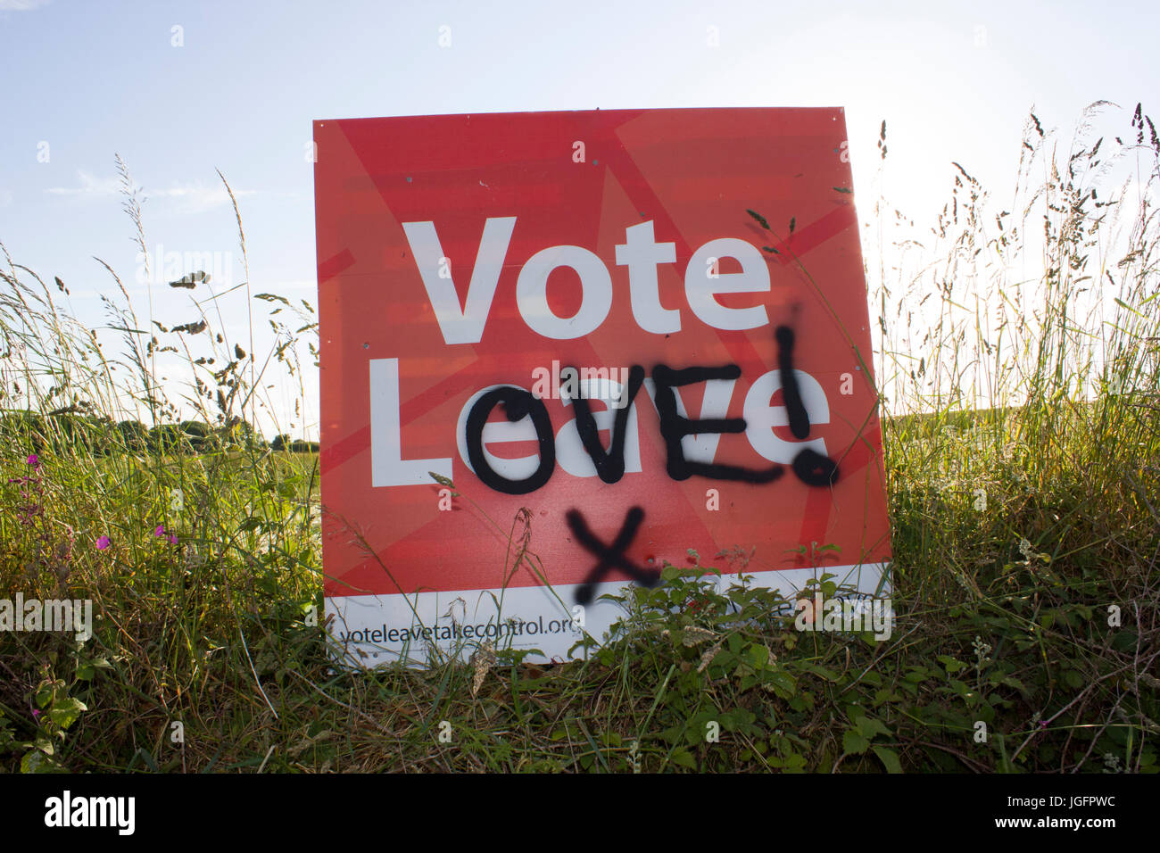 Brexit - A vote leave Europe sign that has been vandalised with graffiti to say vote love. Highlights the difference in opinion during the referendum. Stock Photo