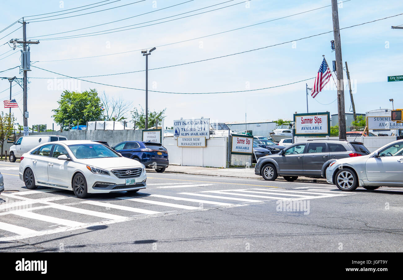 Bronx, USA - June 11, 2017: City Island road with signs of marina and harbor with American flags Stock Photo