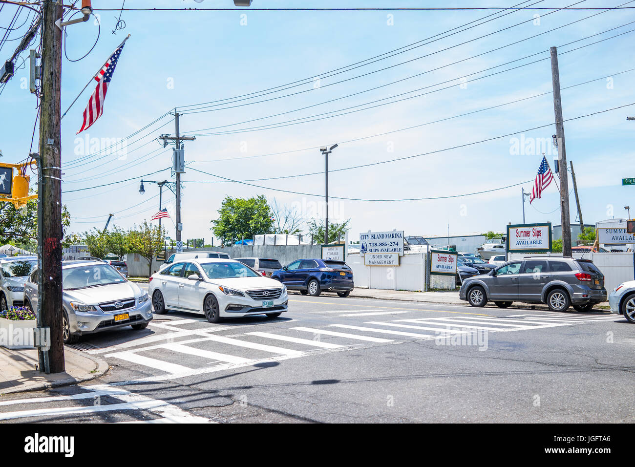 Bronx, USA - June 11, 2017: City Island road with signs of marina and harbor with American flags Stock Photo