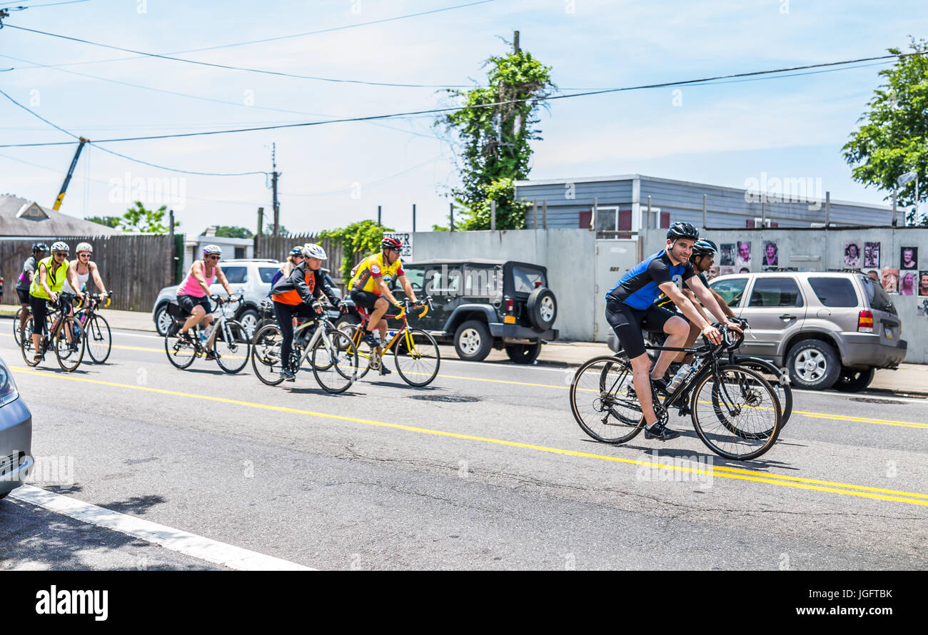 Bronx, USA - June 11, 2017: People riding bicycles in weekend marathon race on outside street or road in City Island by harbor Stock Photo