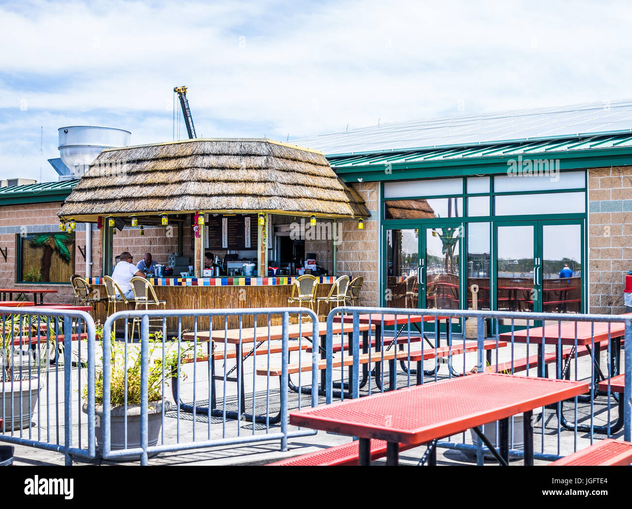 Bronx, USA - June 11, 2017: City Island restaurant with outdoors outside picnic tables seating area and tiki bar Stock Photo