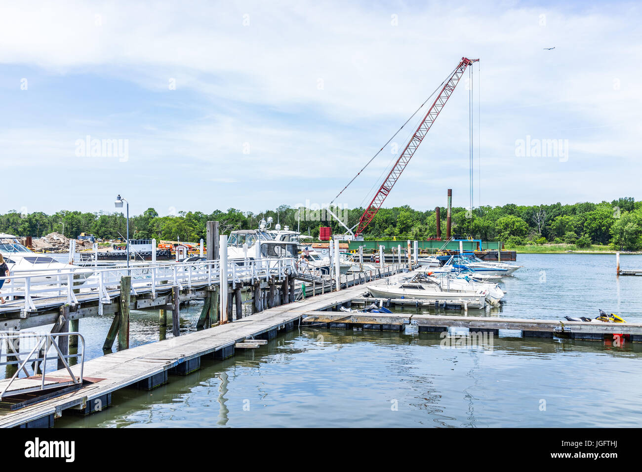 Bronx, USA - June 11, 2017: City Island harbor with boats and construction crane Stock Photo