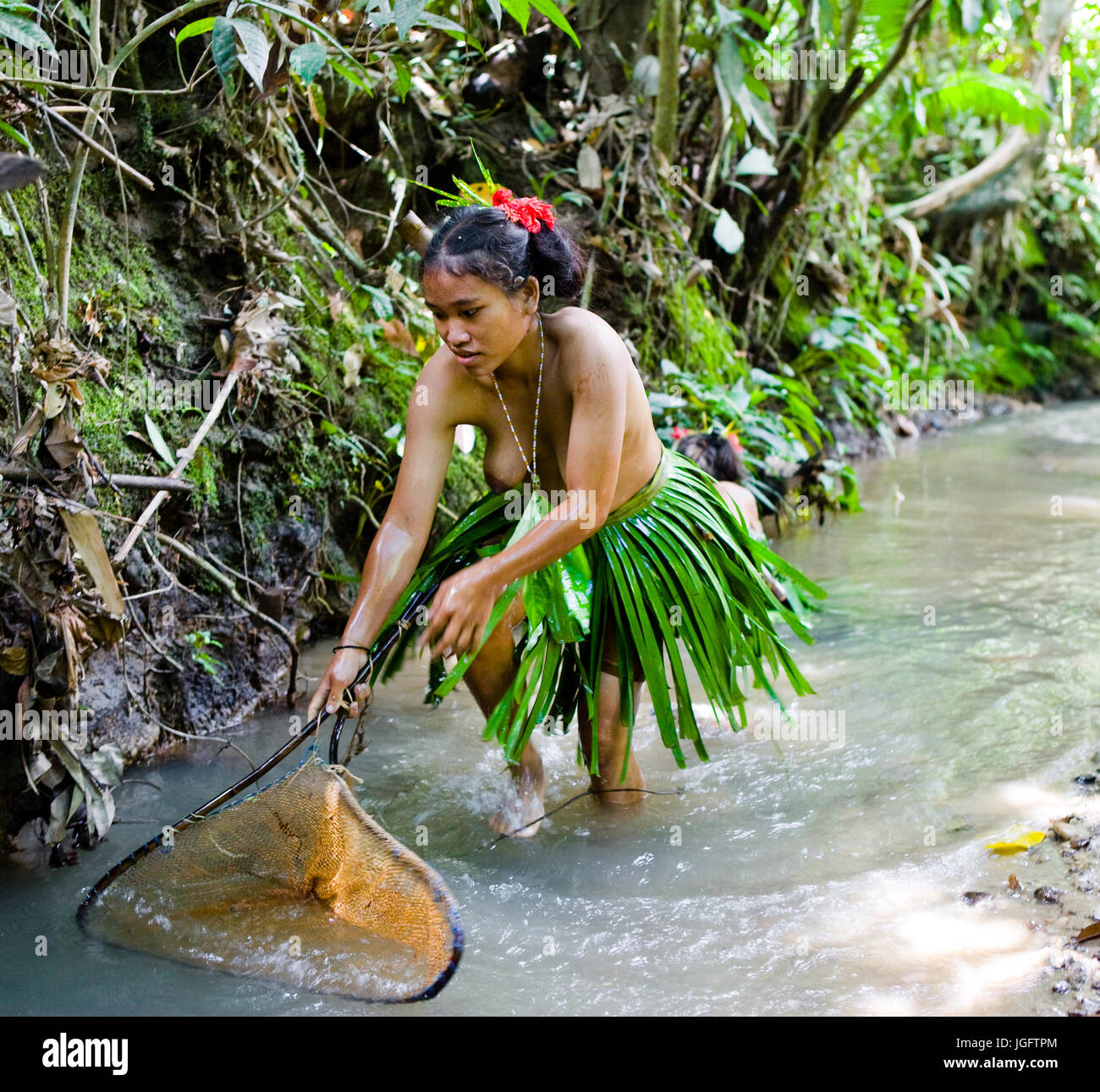 MENTAWAI PEOPLE, WEST SUMATRA, SIBERUT ISLAND, INDONESIA – 16 NOVEMBER 2010: Women Mentawai tribe fishing. Stock Photo