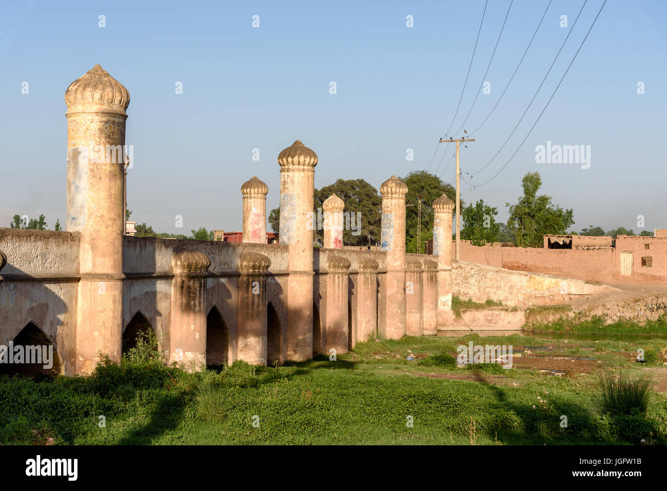 Mughal style arch bridge over the canal in suburbs of Peshawar city, Pakistan Stock Photo