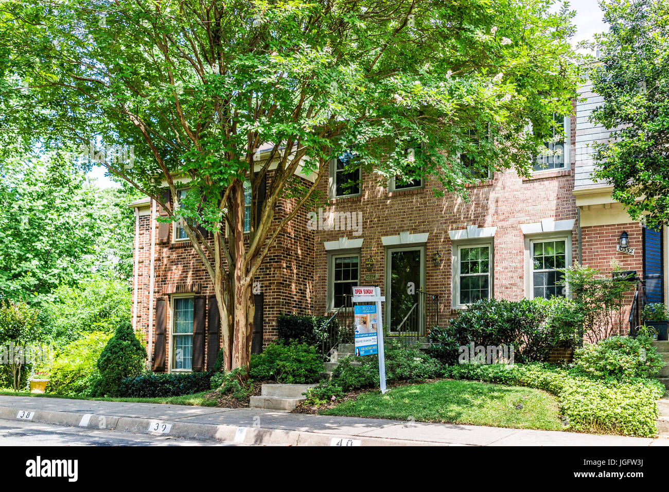 Fairfax, USA June 17, 2017 Real estate sign in front of townhouse with open sunday sign Stock