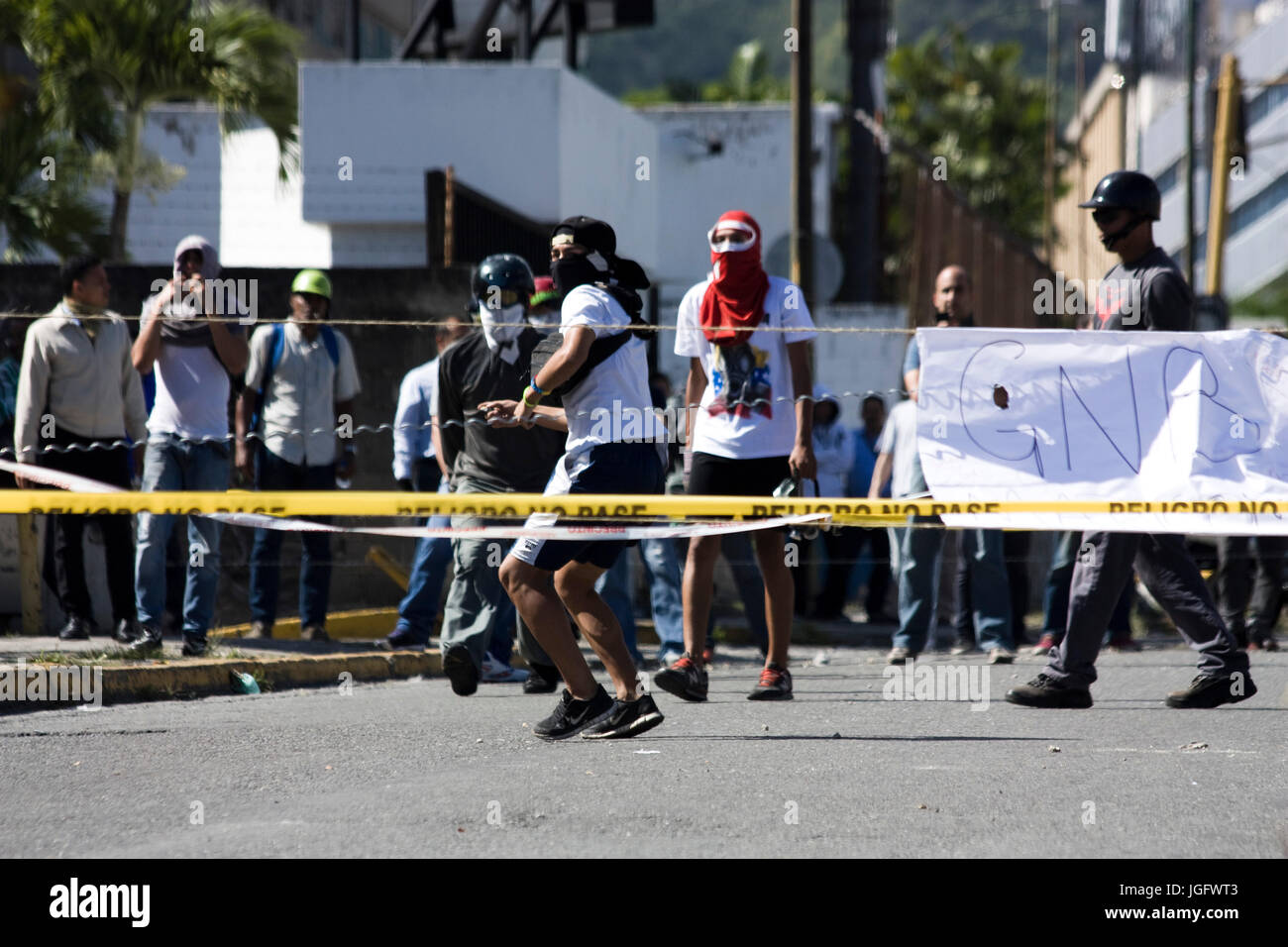 Demonstrators confront the Bolivarian National Guard during a protests named 'El Trancazo' against the government of Nicolás Maduro in Caracas. Stock Photo