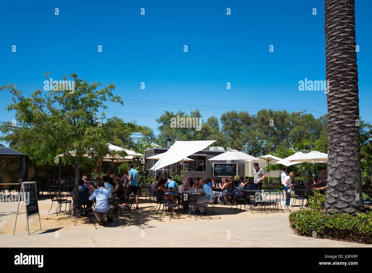 Visitors dine outdoors and taste wines at Wente winery in Livermore Wine Country, Livermore, California, June 25, 2017. Founded in 1883, Wente is the United States' oldest continuously operating family owned vineyard. Stock Photo