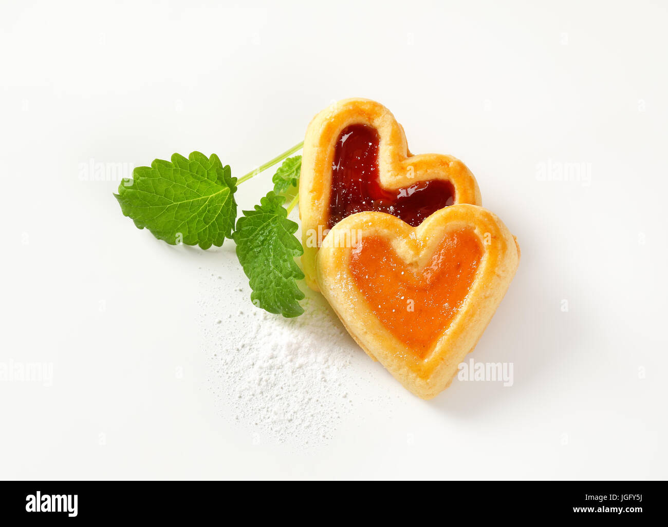 Heart shaped shortbread cookies with apricot and cherry jam filling