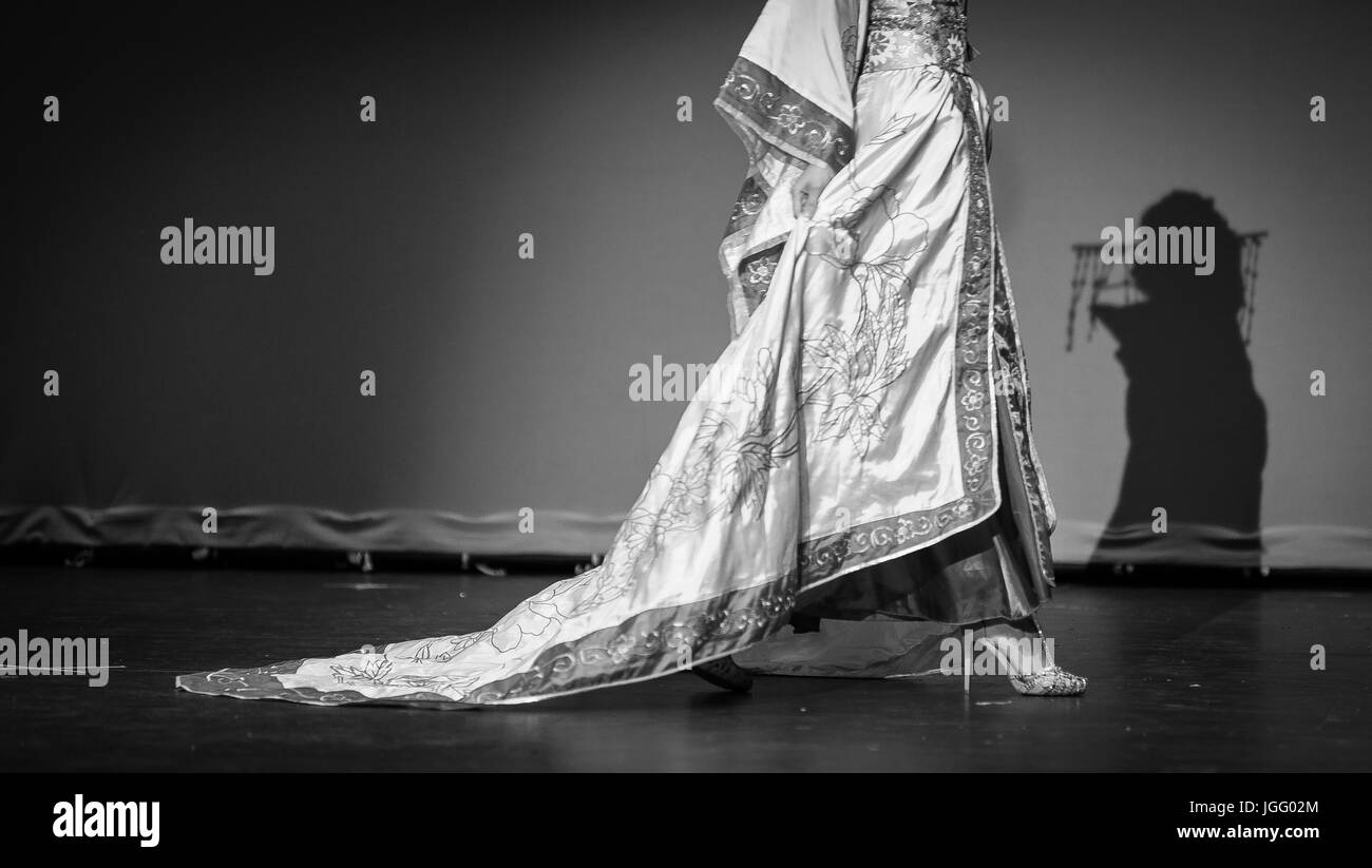Model wearing an Asian robe walking on a catwalk Stock Photo