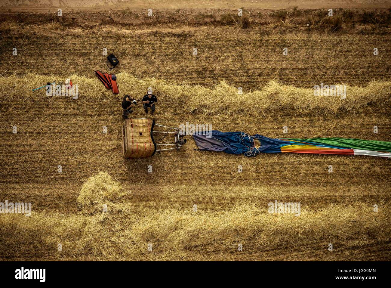 Igualada, Spain. 6th July, 2017. A hot air balloon has been folded after landing next to a field path after a first flight at the 21st European Balloon Festival. The first flight at the 21st edition of Igualada's four day long European Balloon Festival, the biggest concentration, competition and festival of hot air balloons in Spain featuring over 50 international teams, are underway. Credit: Matthias Oesterle/Alamy Live News Stock Photo