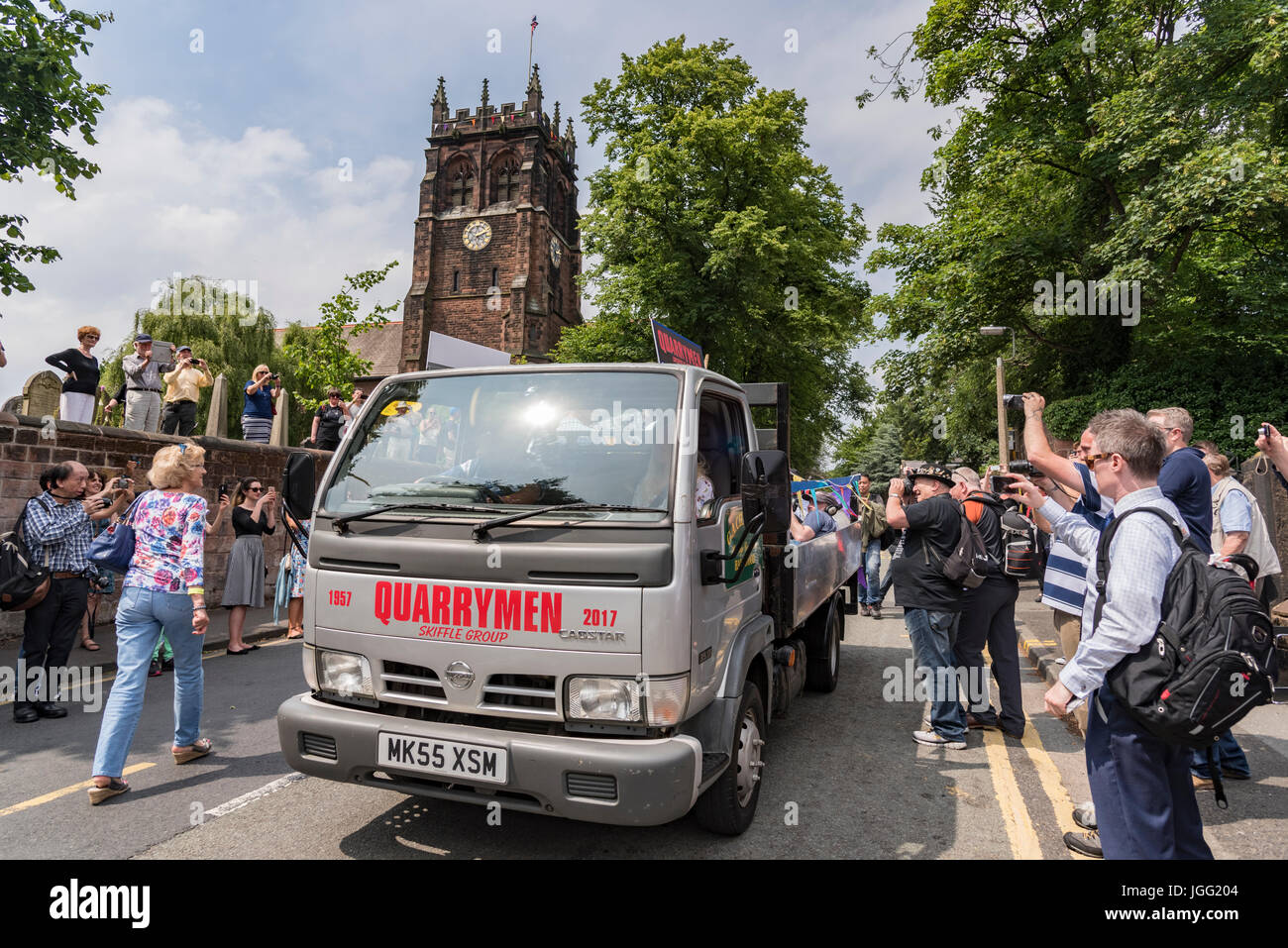 Woolton, Liverpool, UK. 6th July 2017. A parade was held in Woolton Liverpool today to mark the day 60 years ago at the St. Peter's church fete that brought John Lennon and Paul McCartney together to form the Beatles. John Lennon's original band The Quarrymen took a ride round the village on a local lorry and today surviving members of the group recreated the drive with original lorry driver Dougie Chadwick at the wheel. Credit: John Davidson/Alamy Live News Stock Photo