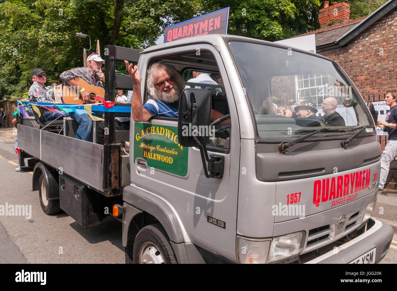 Woolton, Liverpool, UK. 6th July 2017. A parade was held in Woolton Liverpool today to mark the day 60 years ago at the St. Peter's church fete that brought John Lennon and Paul McCartney together to form the Beatles. John Lennon's original band The Quarrymen took a ride round the village on a local lorry and today surviving members of the group recreated the drive with original lorry driver Dougie Chadwick at the wheel. Credit: John Davidson/Alamy Live News Stock Photo