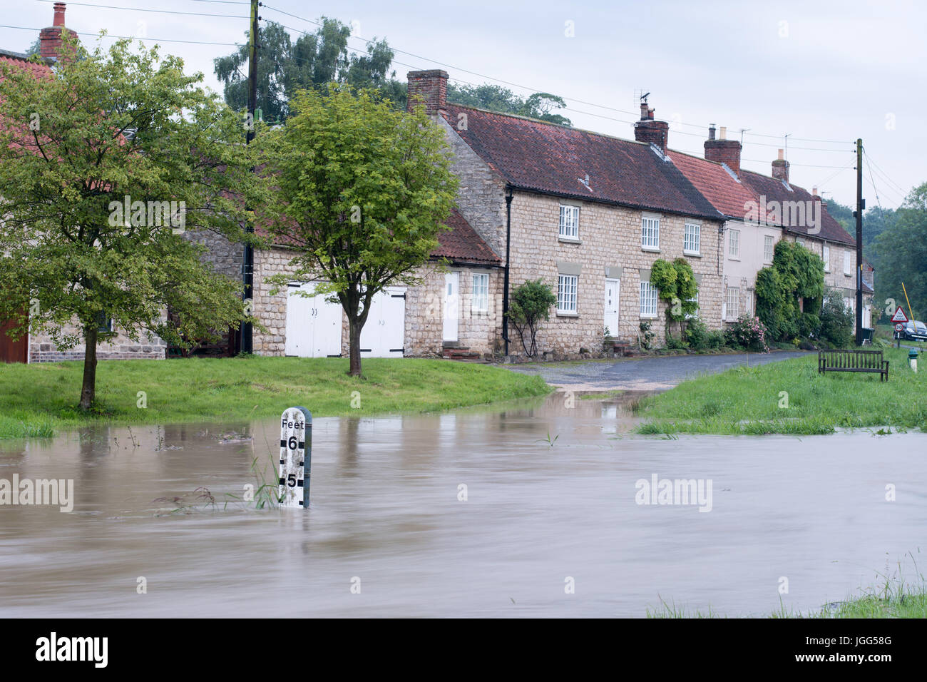 Normally a trickle of a beck, rises to nearly 5 ft in the village of Settrington, North Yorkshire. Credit: Richard Smith/Alamy Live News Stock Photo