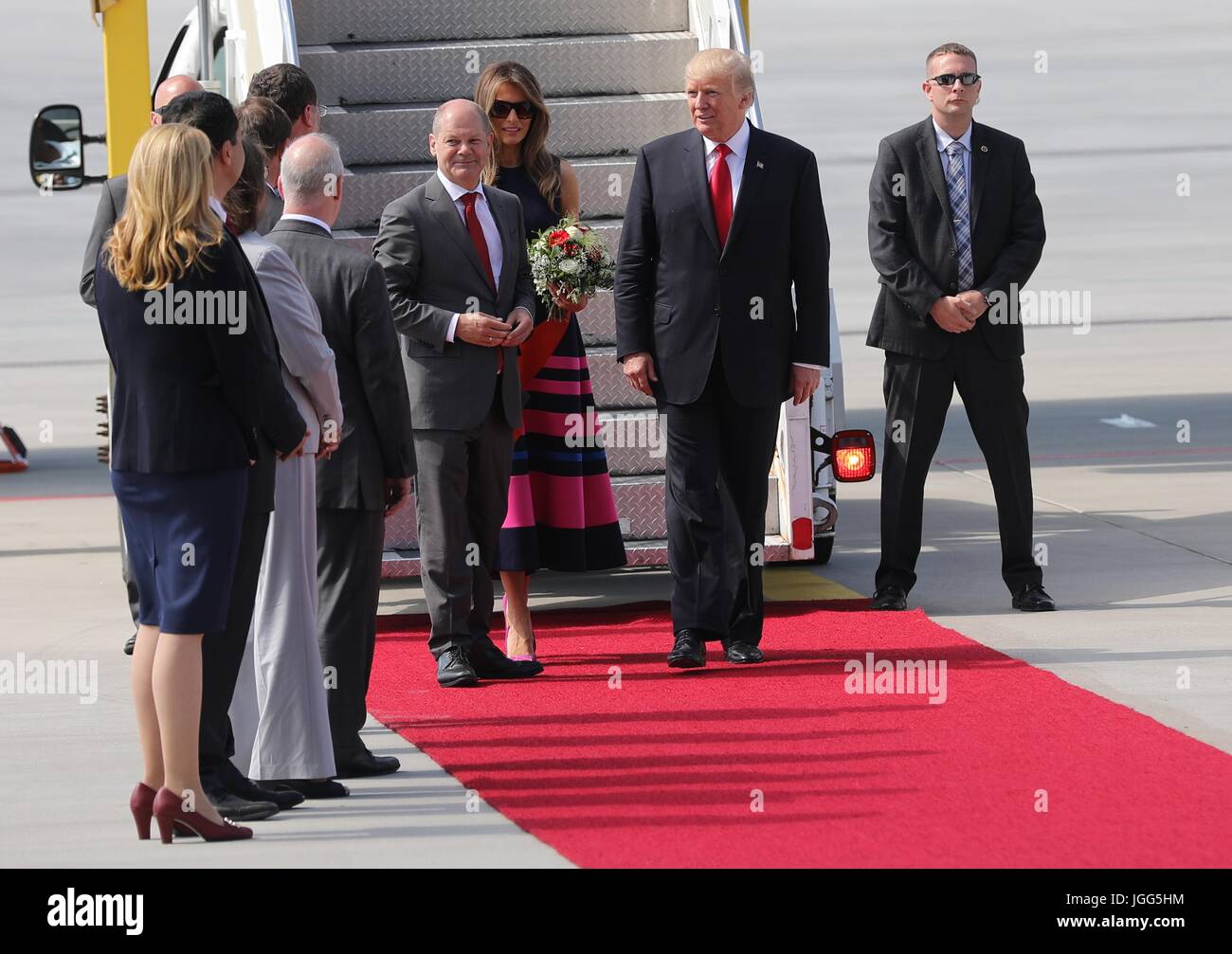 Hamburg, Germany. 06th July, 2017. The Mayor of Hamburg Olaf Scholz, center, welcomes U.S. President Donald Trump and First Lady Melania Trump on arrival for the start of the G20 Summit meeting at Hamburg Airport July 6, 2017 in Hamburg, Germany. (U.S. State Department via Planetpix) Credit: Planetpix/Alamy Live News Stock Photo