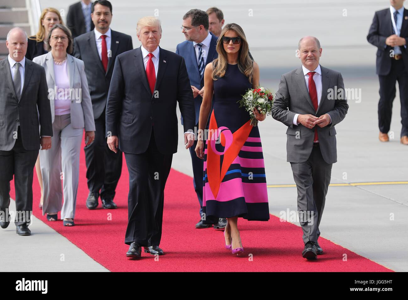 Hamburg, Germany. 06th July, 2017. U.S. President Donald Trump and First Lady Melania Trump are escorted by the Mayor of Hamburg Olaf Scholz, right, and embassy staff on arrival for the start of the G20 Summit meeting at Hamburg Airport July 6, 2017 in Hamburg, Germany. (U.S. State Department via Planetpix) Credit: Planetpix/Alamy Live News Stock Photo