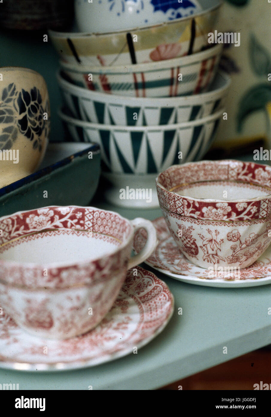 Collection of vintage cups and saucers and pottery bowls Stock Photo