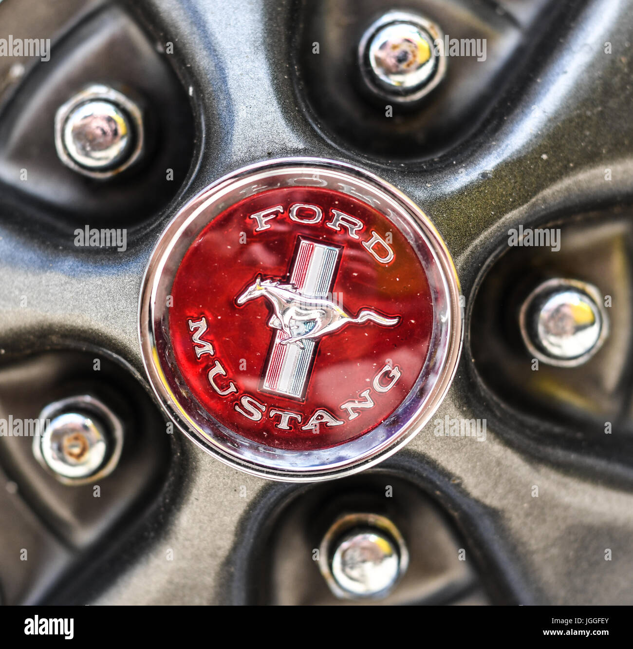 Classic Ford Mustang logo on hubcap with lugnuts Stock Photo