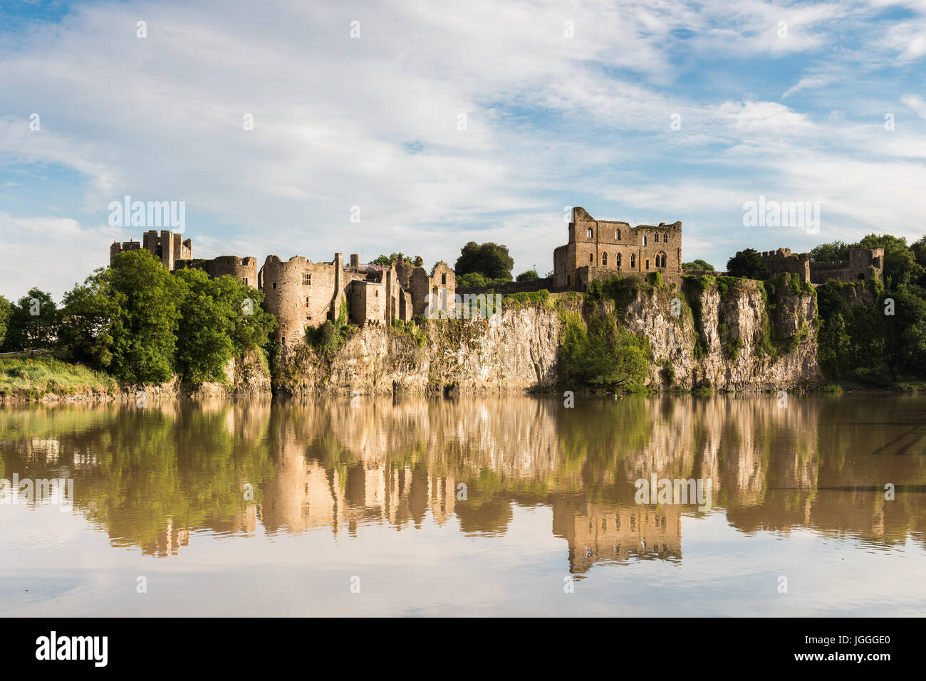 Chepstow Castle reflected in the waters of the River Wye. Stock Photo