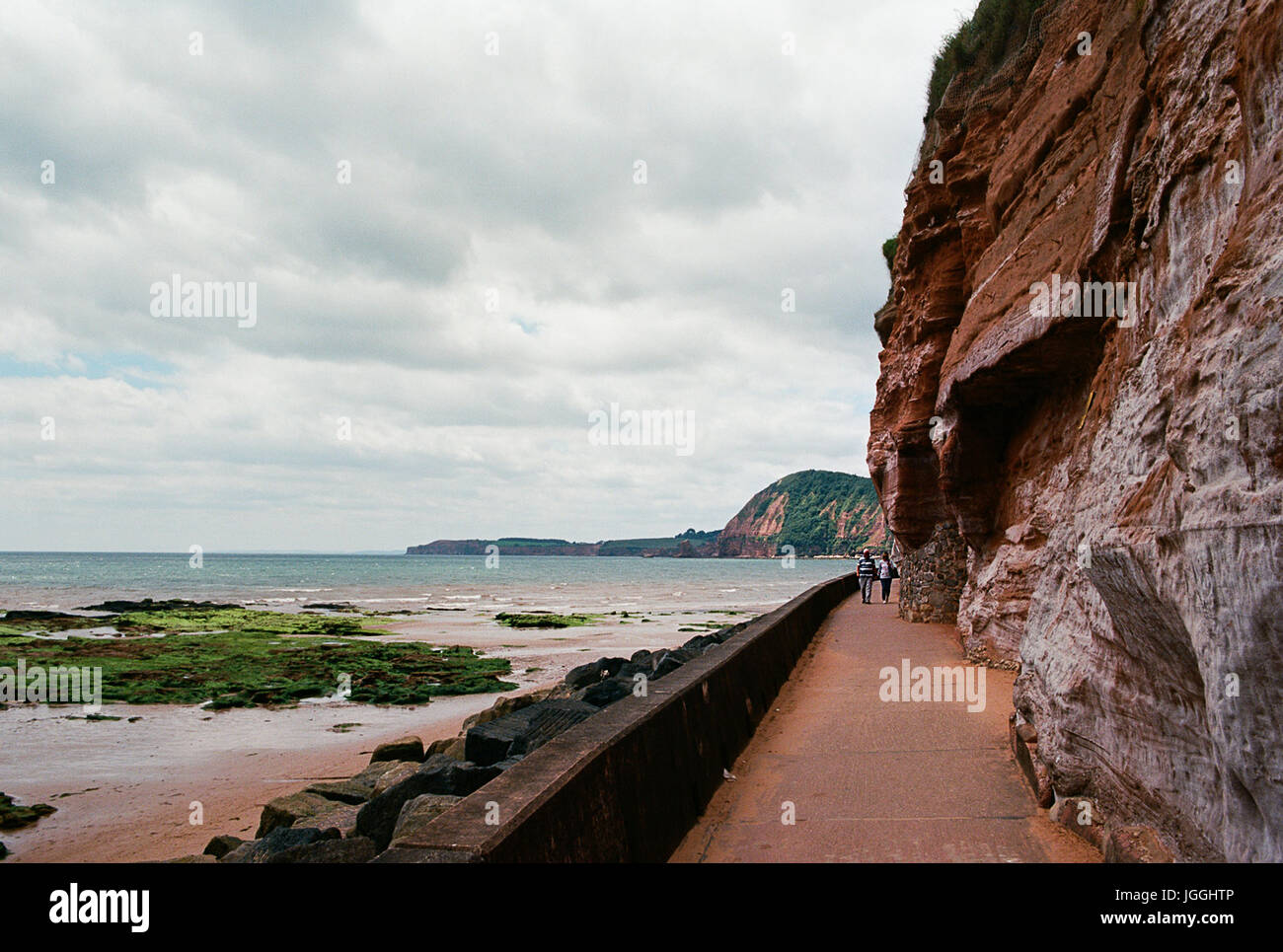 The coastal path along the shoreline at Sidmouth, Devon UK, looking west Stock Photo