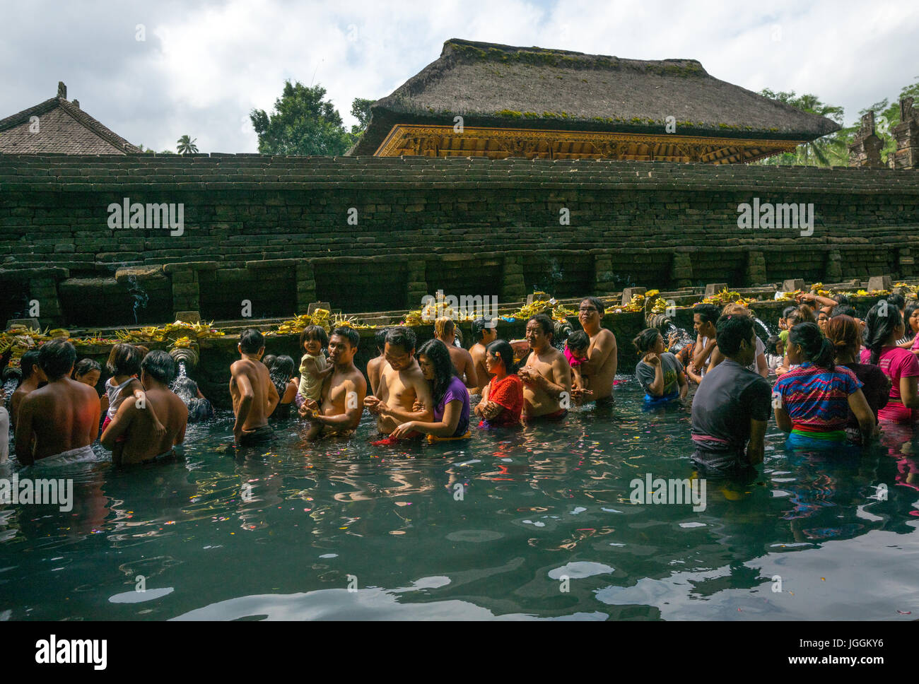 Worshipers taking a bath in the purifying pool at Tirta Empul temple, Bali island, Tampaksiring, Indonesia Stock Photo