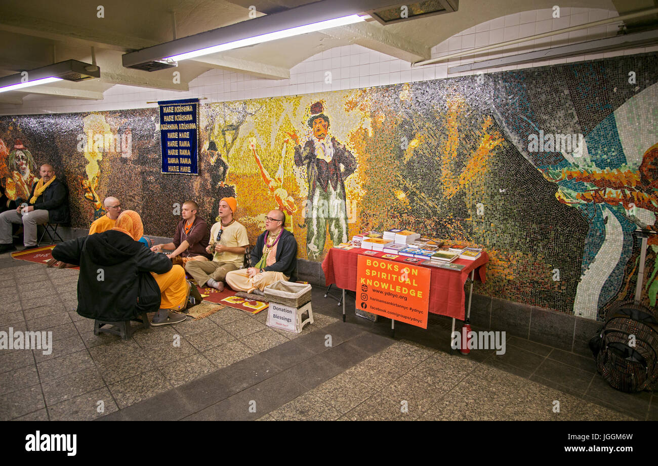 Hare Krishna devotees chanting and soliciting donations at the 34th Street subway station in Manhattan, New York City. Stock Photo