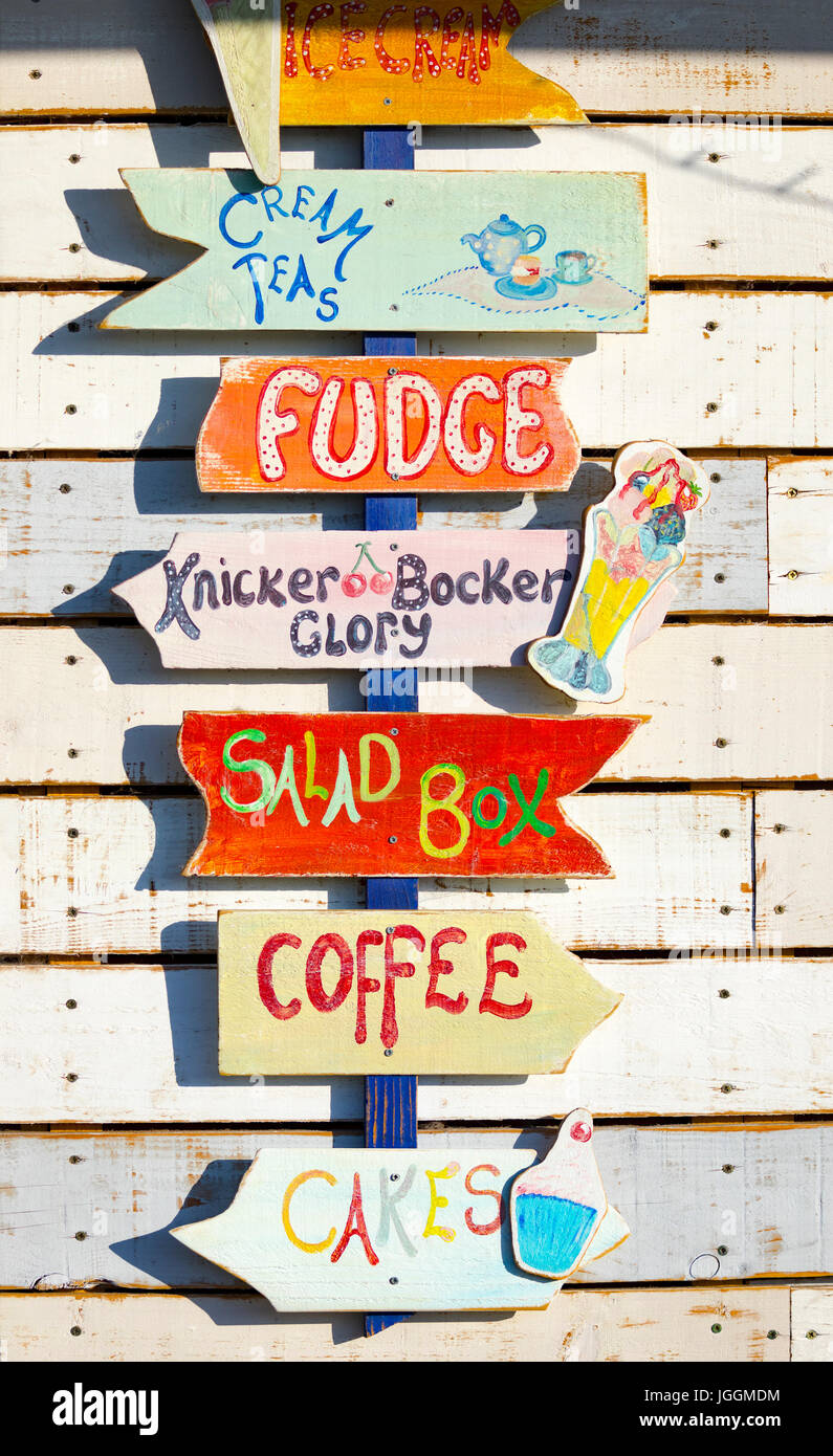 A colourful shop sign outside a cafe at the popular coastal town and harbour of Padstow in Cornwall, England Stock Photo