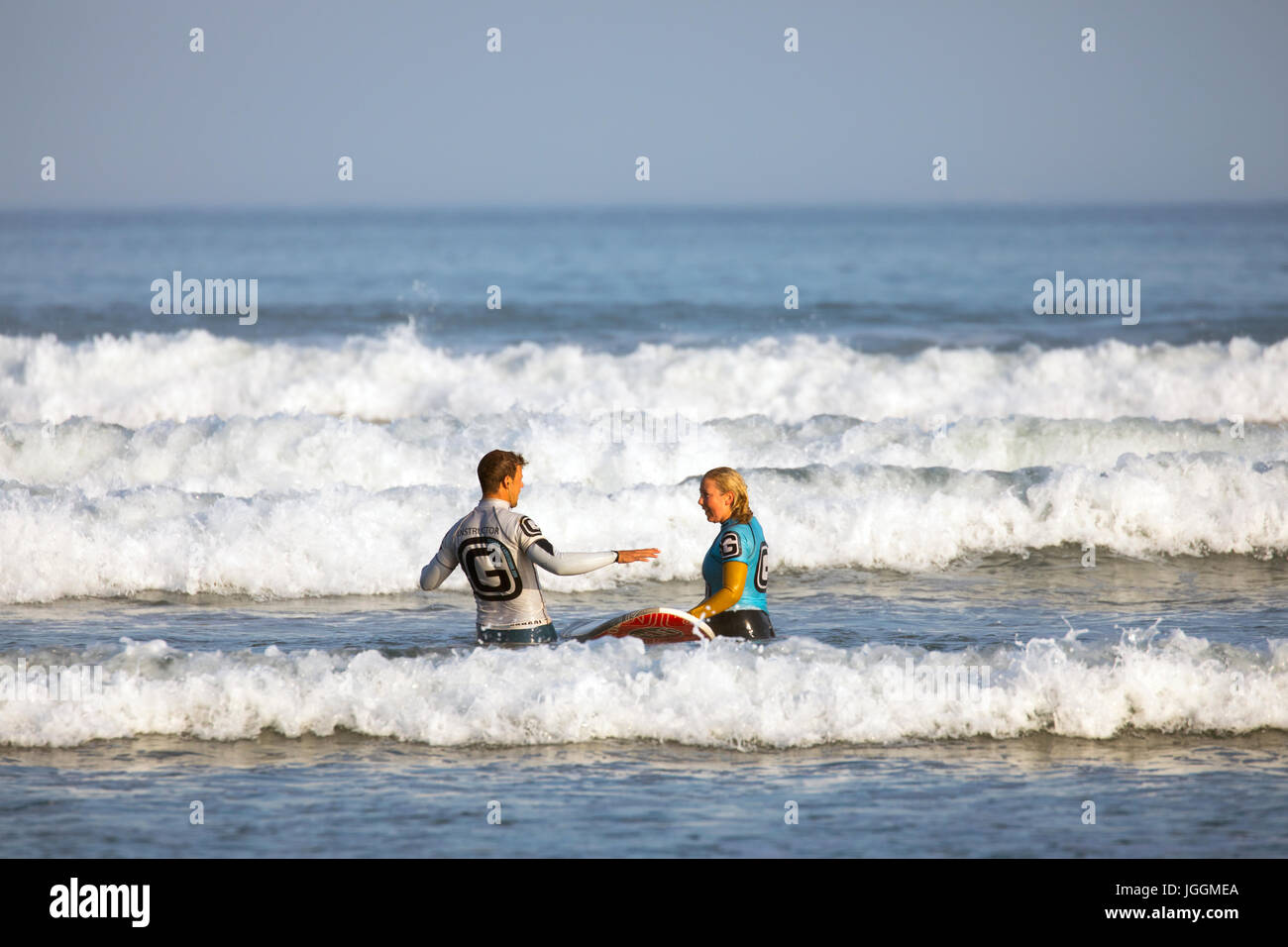 A Surfing Instructor Giving Instruction To A Pretty Female A Surfing Instructor Giving Instruction To A Pretty Female