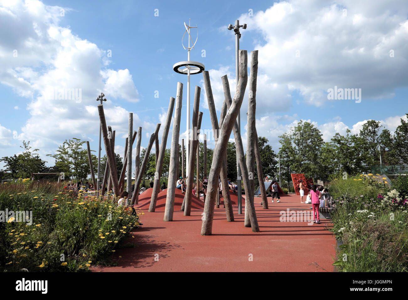 Childrens playground with pole structure & kids playing outside in the Queen Elizabeth Olympic Park in Stratford, East London England UK  KATHY DEWITT Stock Photo