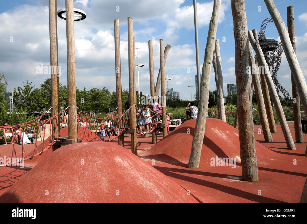Childrens playground with pole structure & kids playing outside in the Queen Elizabeth Olympic Park in Stratford, East London England UK  KATHY DEWITT Stock Photo