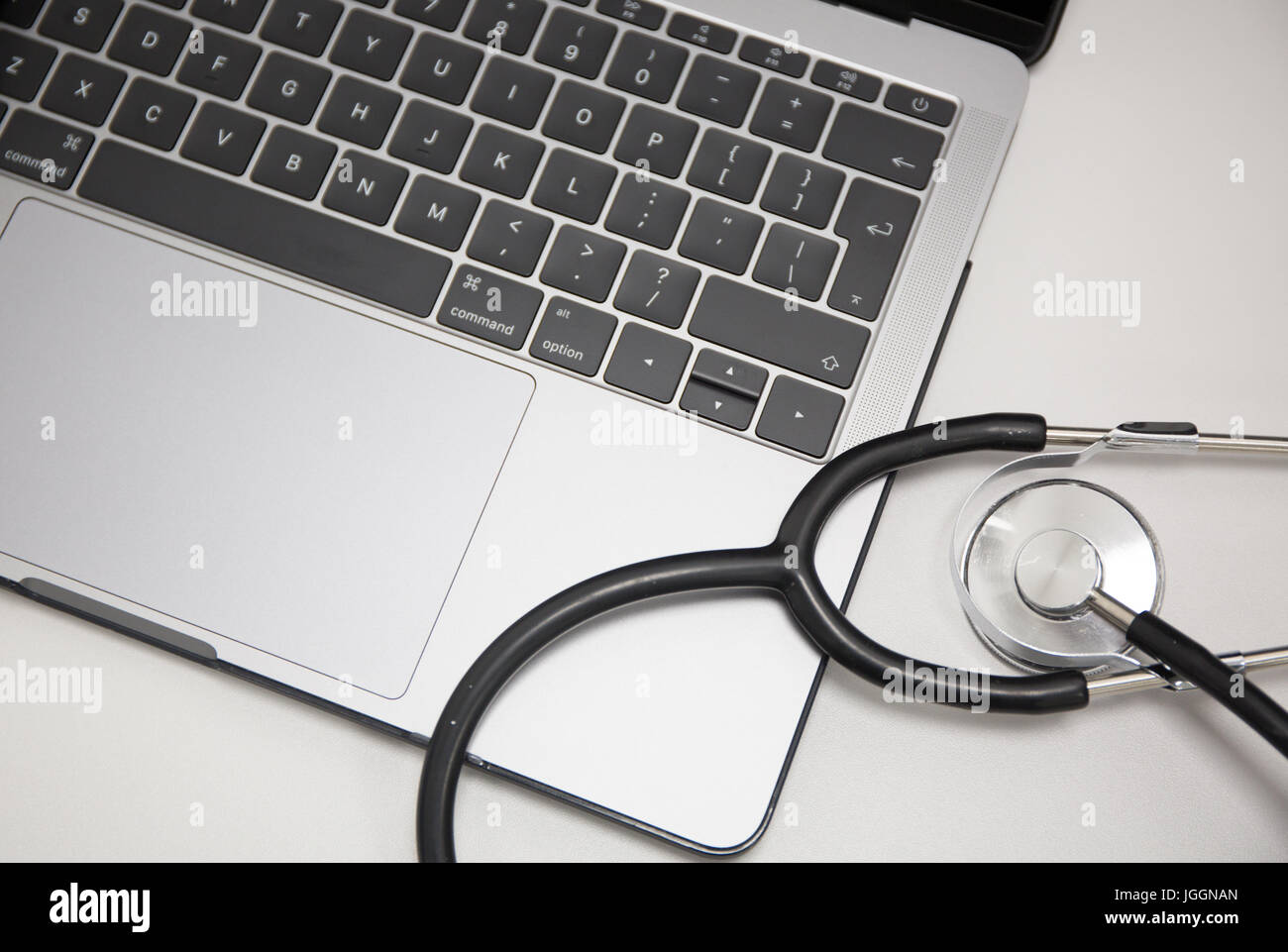 Doctors stethoscope resting on a laptop computer Stock Photo