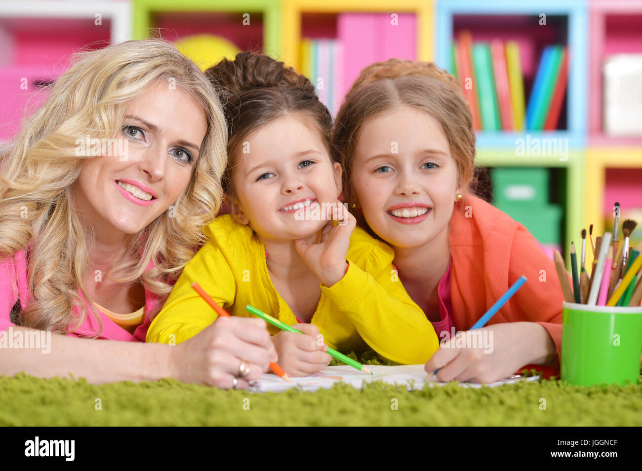Mother with daughters drawing  Stock Photo