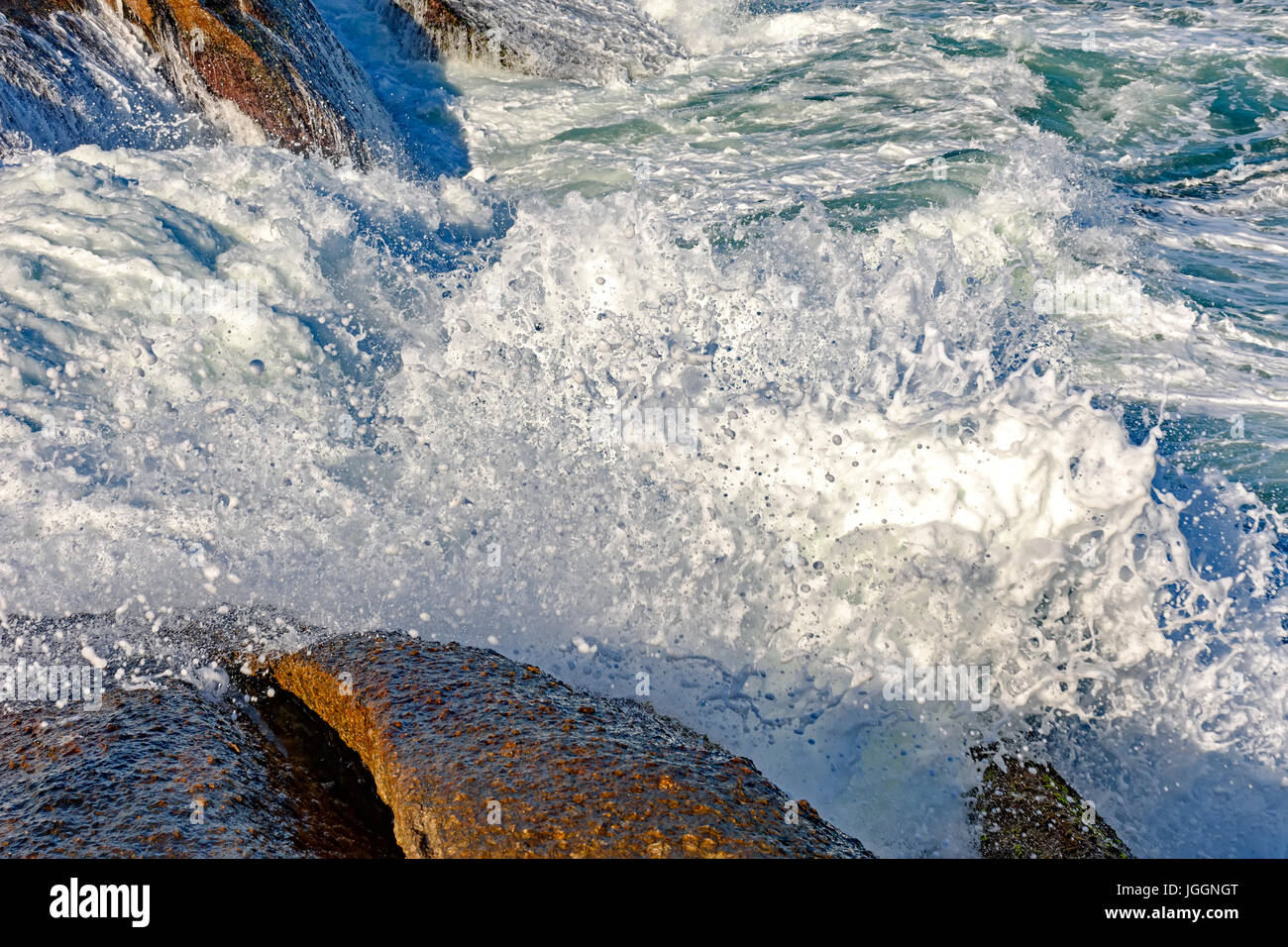 Wave crashing on the rockst of Arpoador beach at Ipanema, Rio de Janeiro Stock Photo