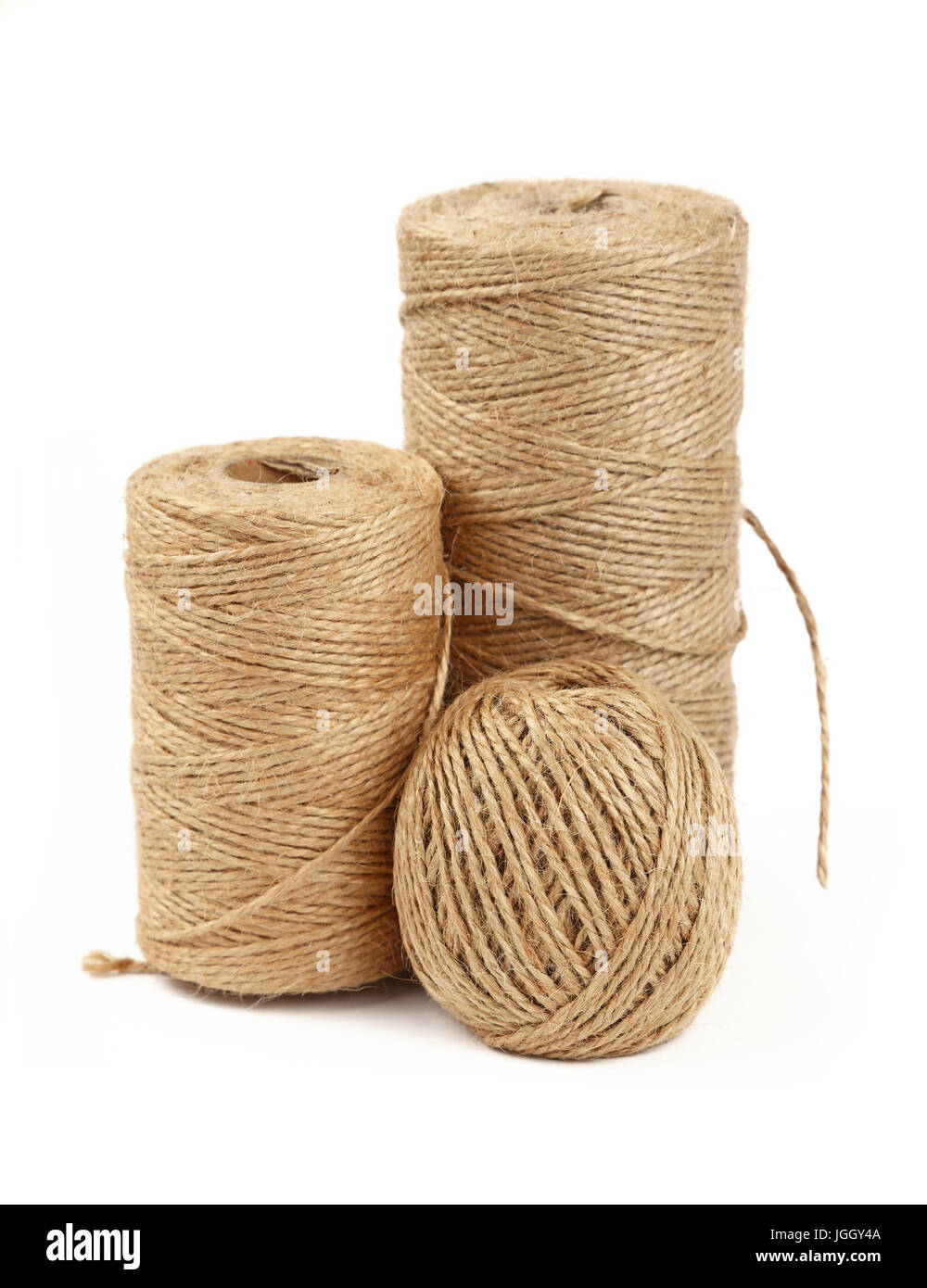 Group of three different coil bobbin of natural brown twine hessian