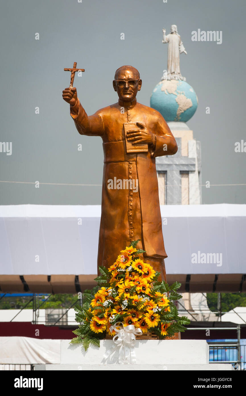 A golden statue of martyred Archbishop Oscar Romero across from the Plaza El Salvador Del mundo (Savior of the World) where preparations are being made for Saturday's ceremony and mass announcing the beatification of Archbishop Oscar Romero. The Archbishop was slain at the alter of his Church of the Divine Providence by a right wing gunman in 1980. Oscar Arnulfo Romero y Galdamez became the fourth Archbishop of San Salvador, succeeding Luis Chavez, and spoke out against poverty, social injustice, assassinations and torture. Romero was assassinated while offering Mass on March 24, 1980. Stock Photo