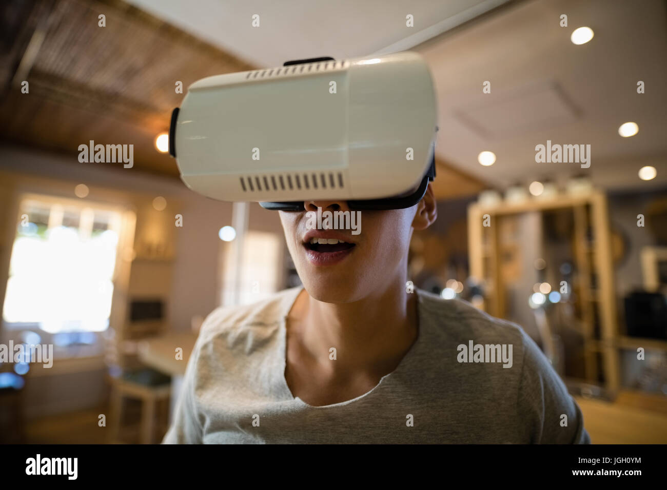 Smiling man using virtual reality headset in restaurant Stock Photo - Alamy