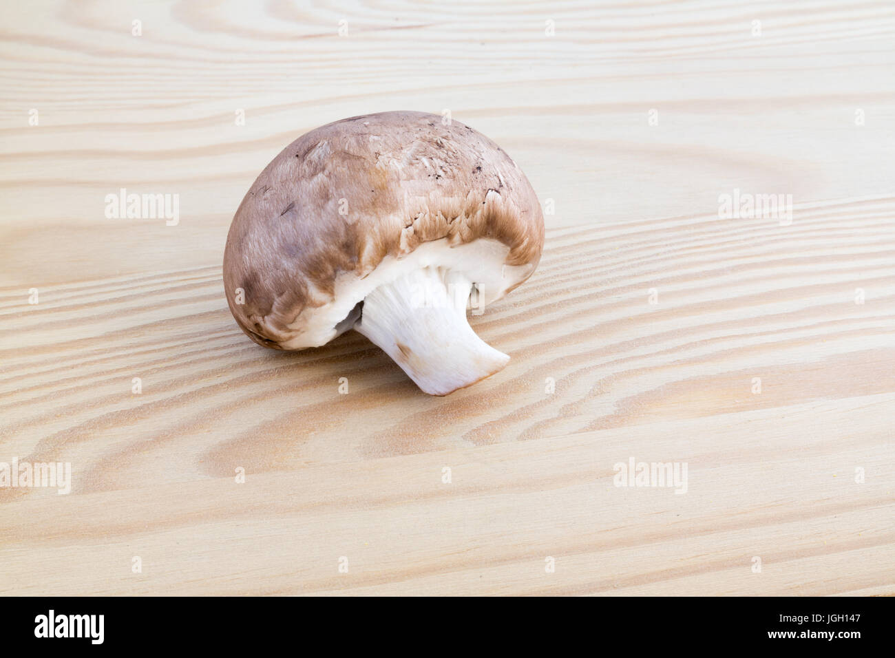 Chestnut mushroom on wooden cutting board Stock Photo