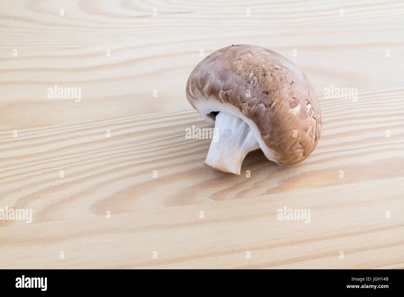 Chestnut mushroom on wooden cutting board Stock Photo