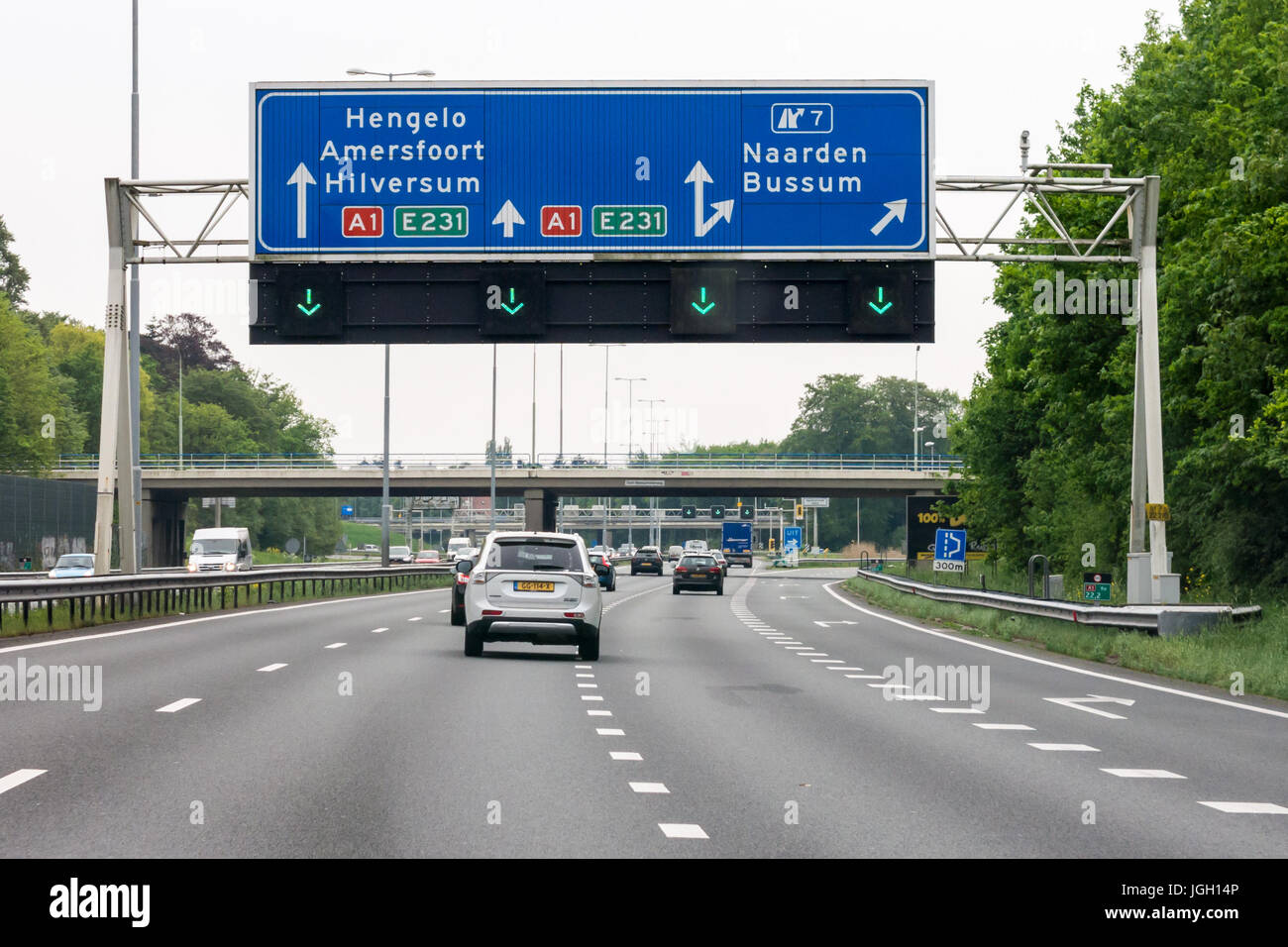 Traffic on motorway A1 and overhead route information signs, Naarden, North Holland, Netherlands Stock Photo