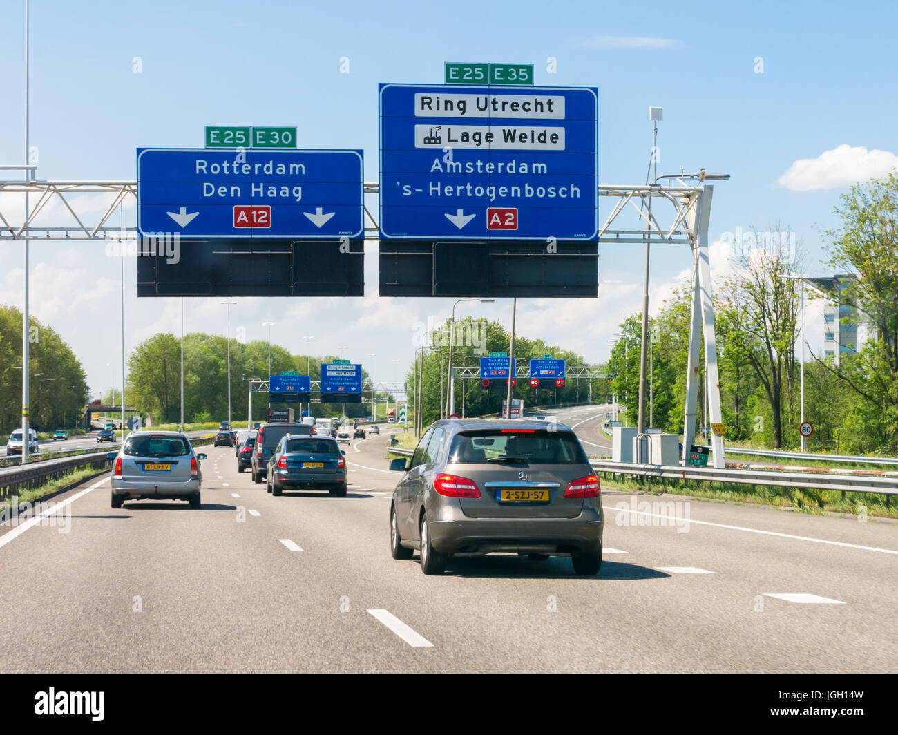 Traffic on motorway A12 and overhead route information signs, Oudenrijn, Utrecht,  Netherlands Stock Photo