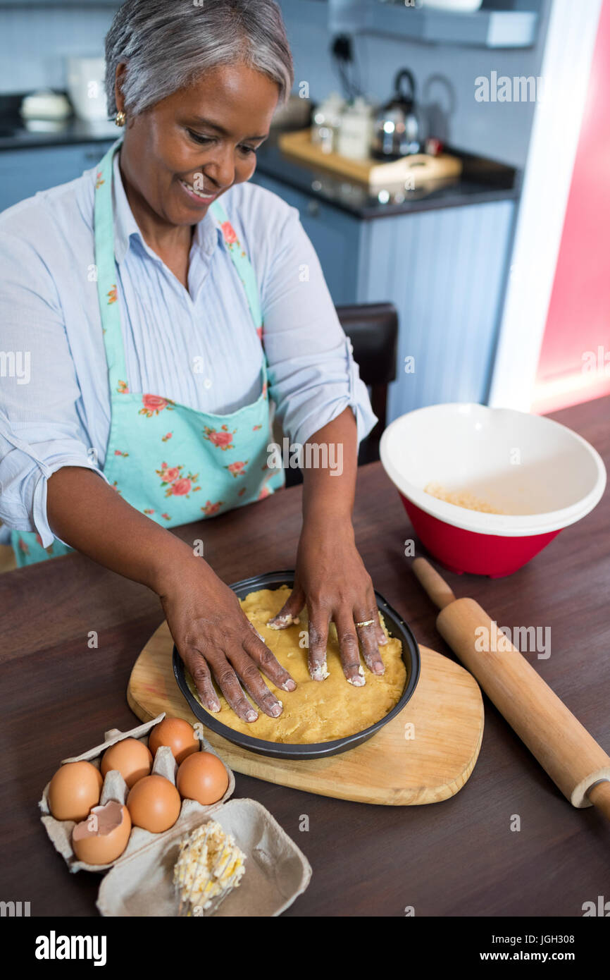 High angle view of smiling woman preparing food n kitchen at home Stock Photo