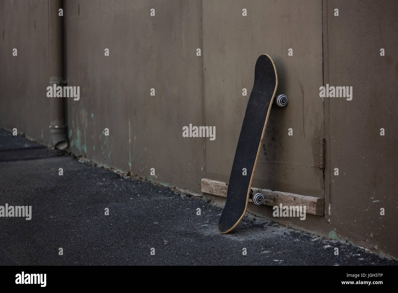 Skateboard leaning by wall Stock Photo Alamy