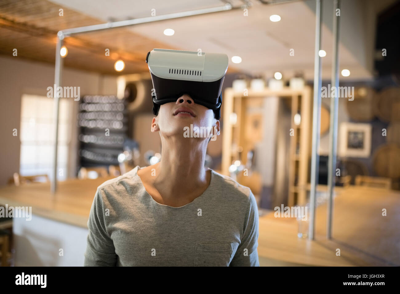 Smiling man using virtual reality headset in restaurant Stock Photo - Alamy