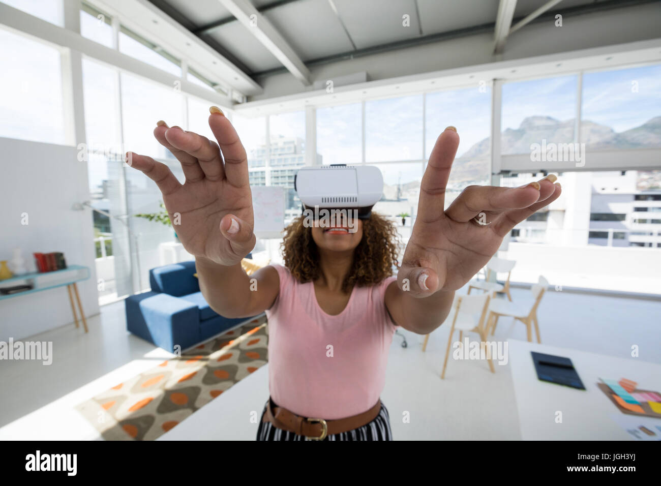 Female executive using virtual reality headset in the office Stock ...