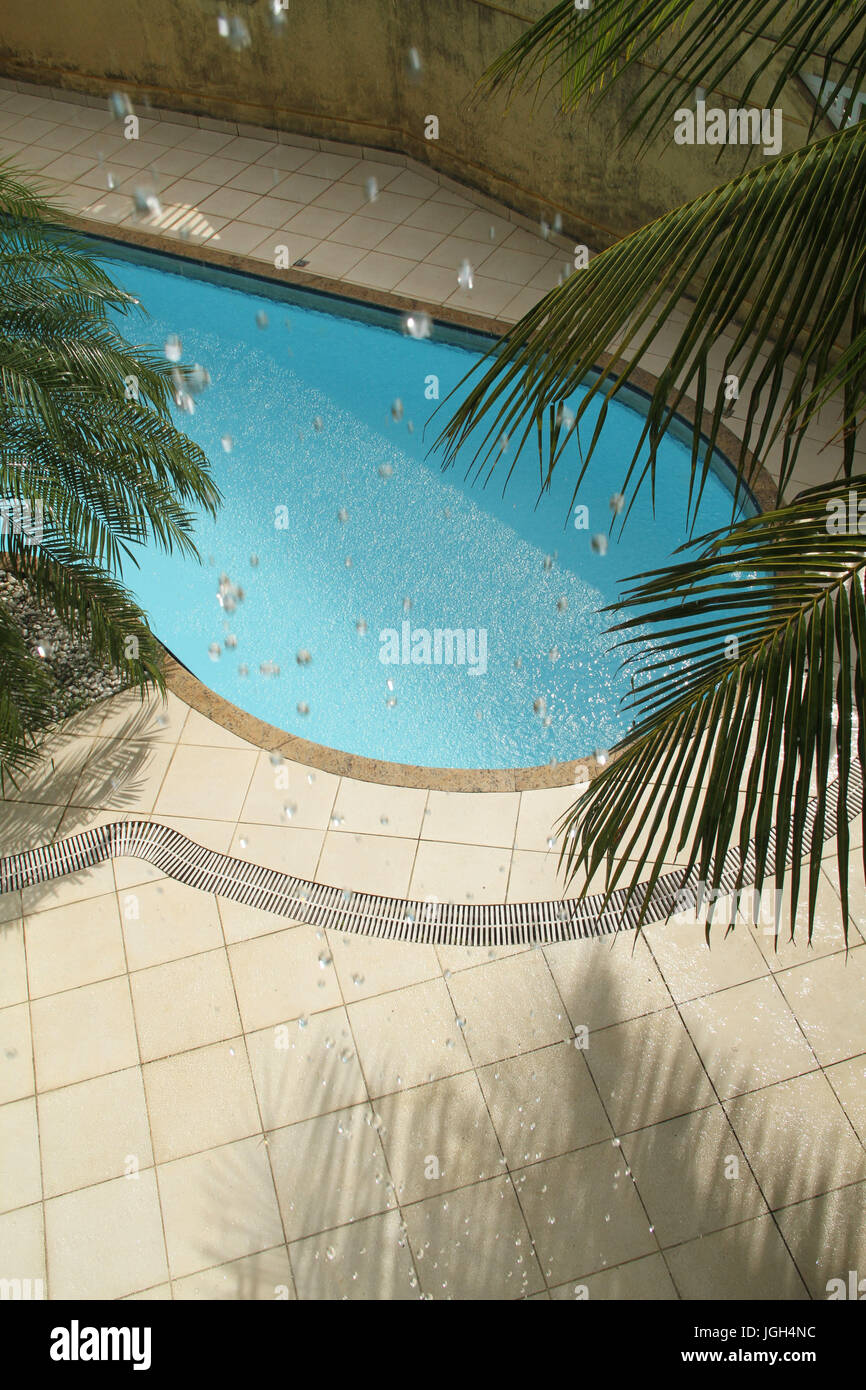 Sun with rain, swimming pool, 2017, Litoral Paulista, Praia Grande, São Paulo, Brazil. Stock Photo