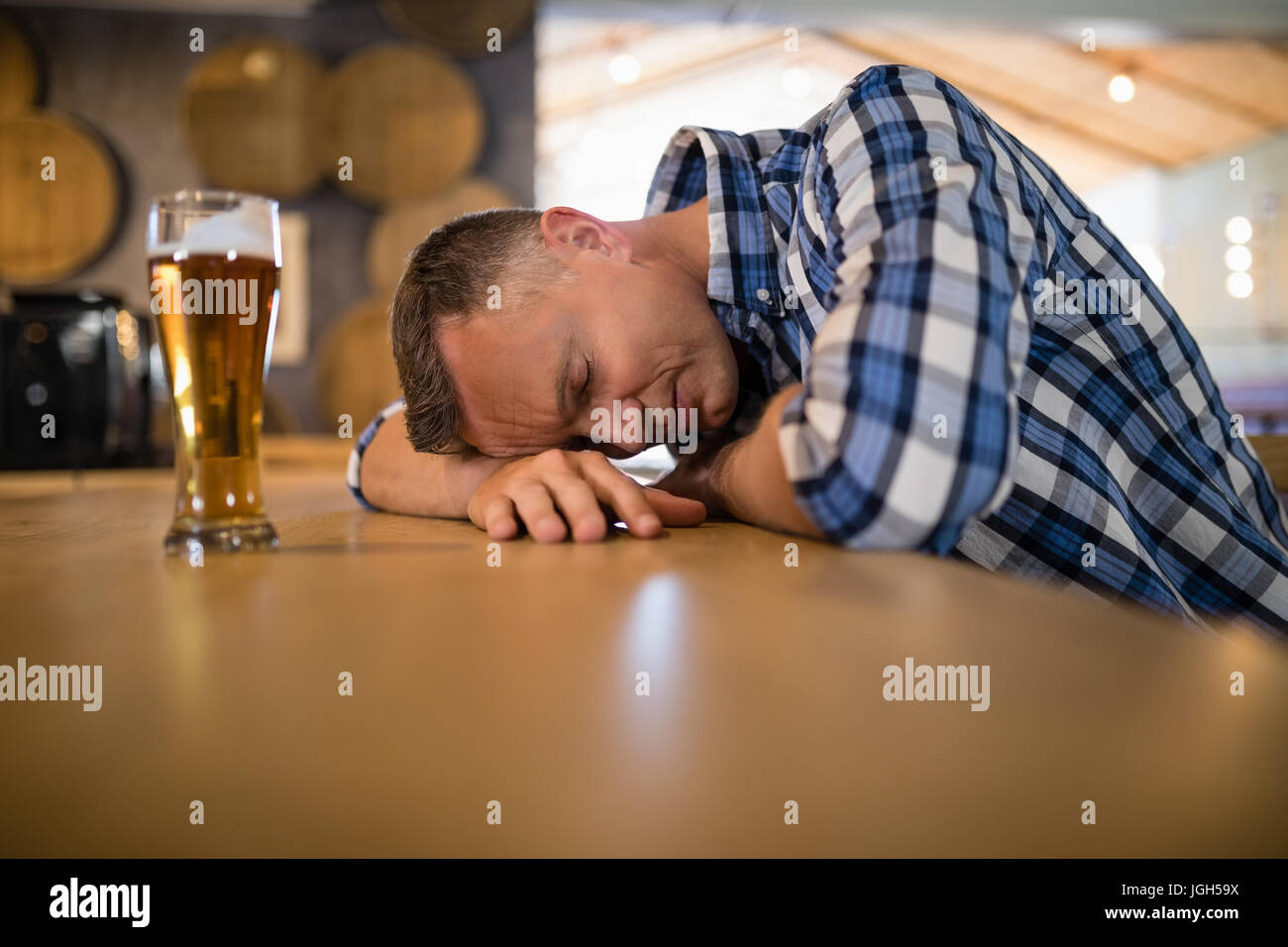 Drunken man sleeping on counter in bar Stock Photo Alamy