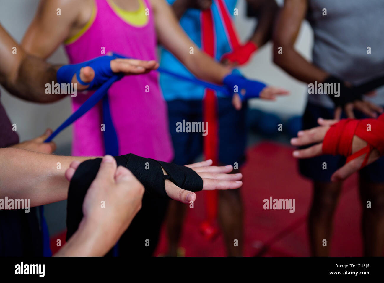 Boxers wrapping bandages on hands in fitness studio Stock Photo Alamy