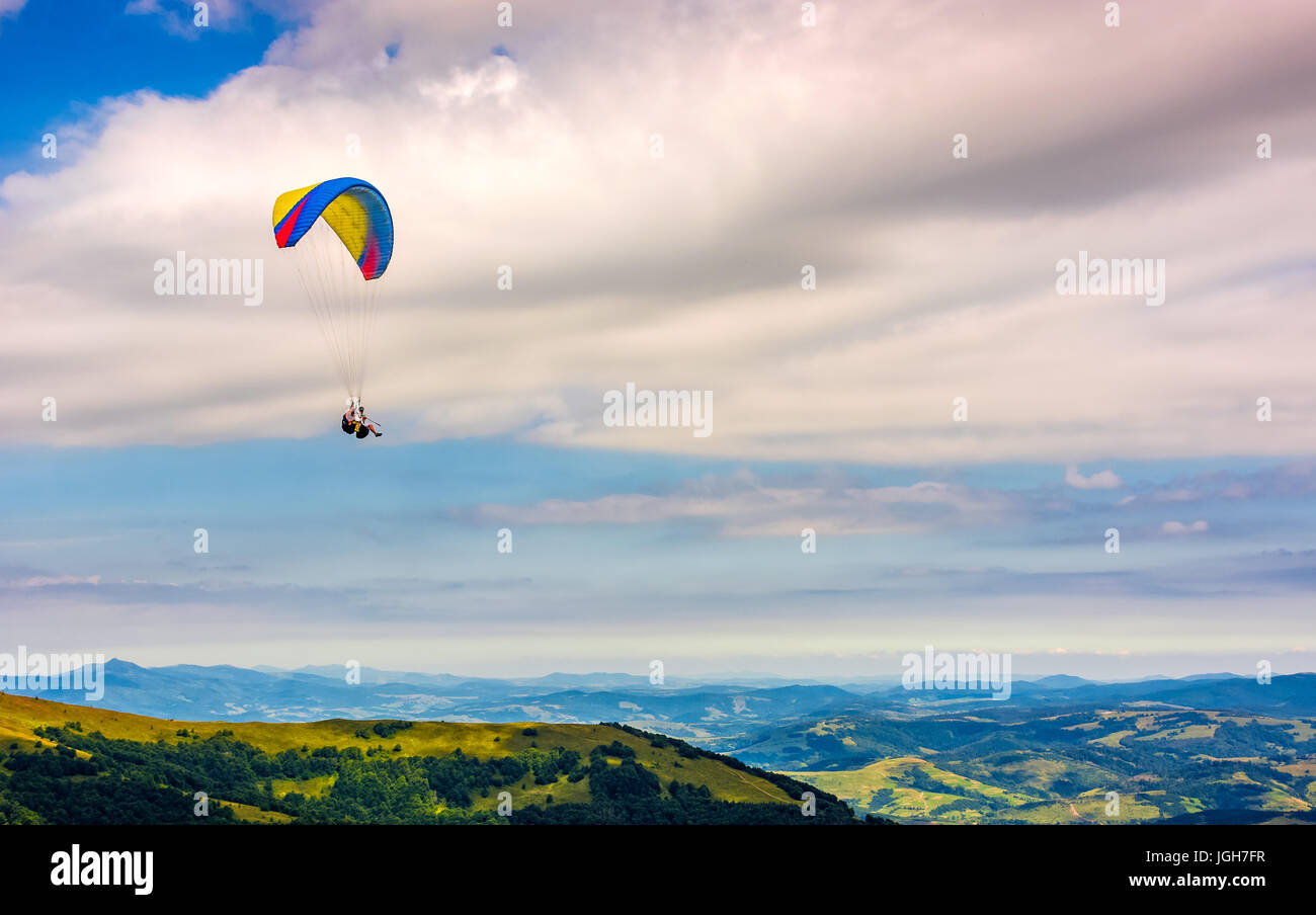 Skydiving flying in the clouds over the mountains. parachute extreme sport Stock Photo