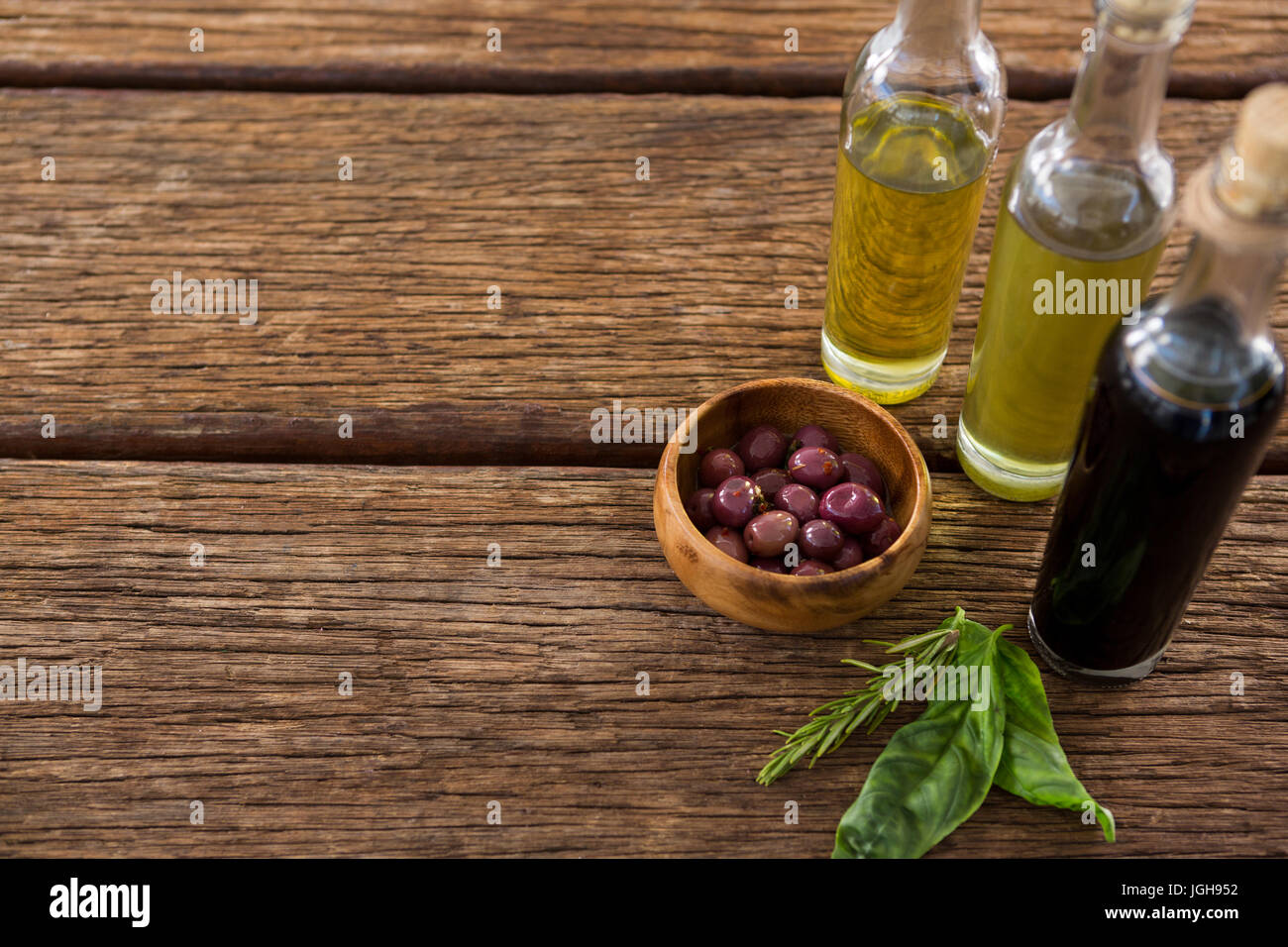 Closeup of marinated olives with balsamic vinegar bottles on table Stock Photo Alamy
