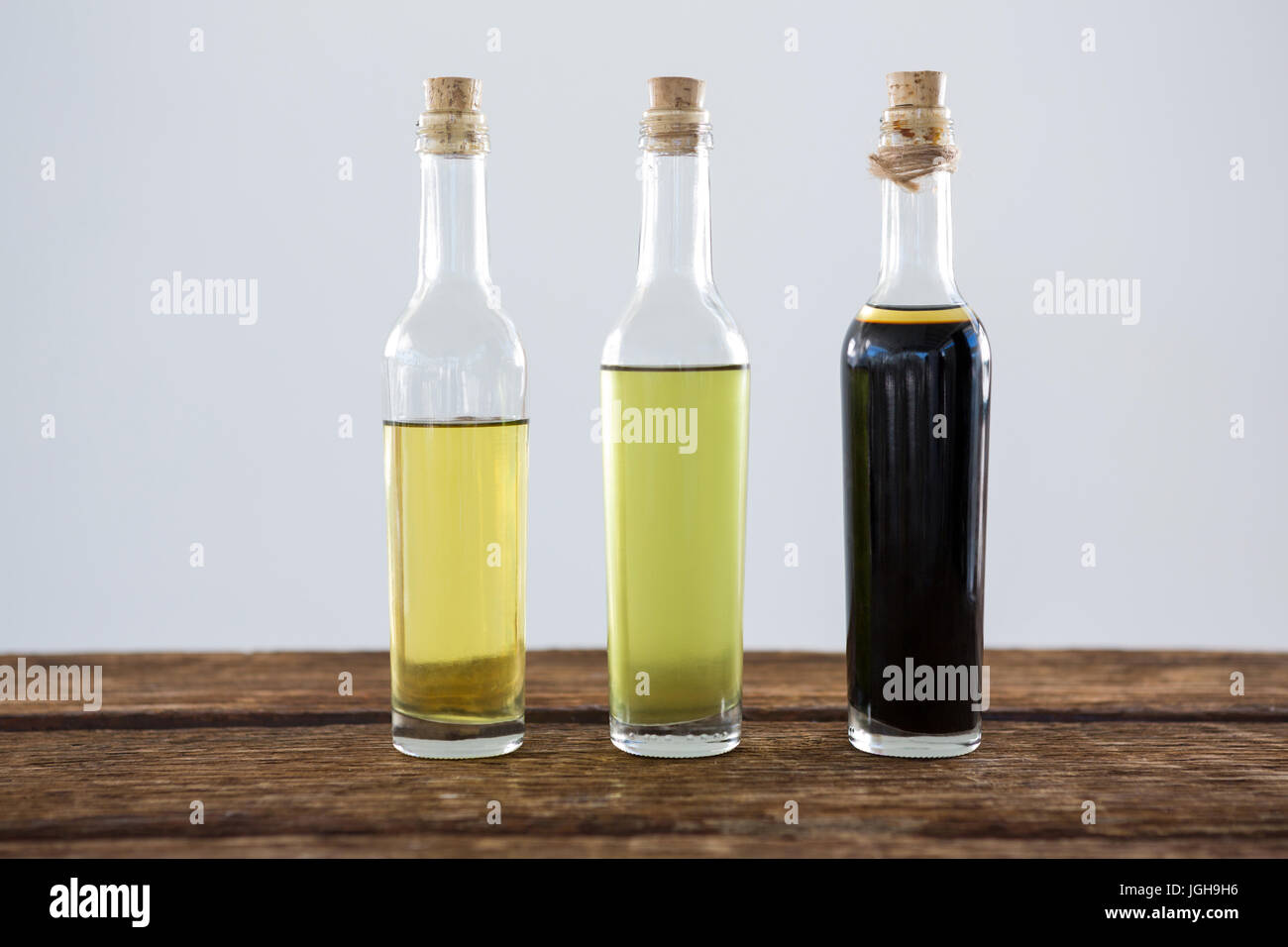 Close-up of olive oil and balsamic vinegar in bottle on table Stock Photo