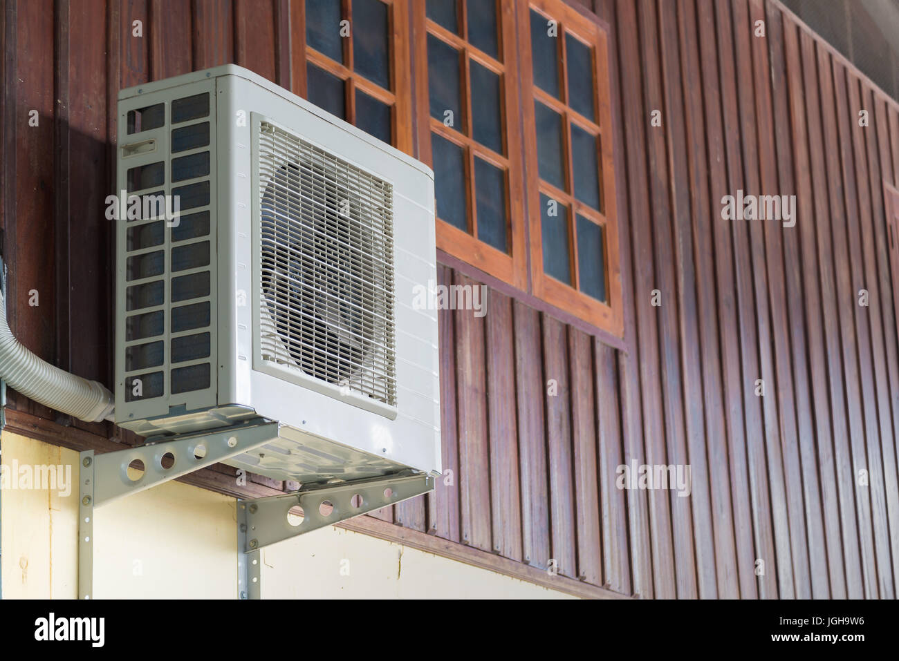 Air conditioning units installed outside the house on wooden wall Stock ...